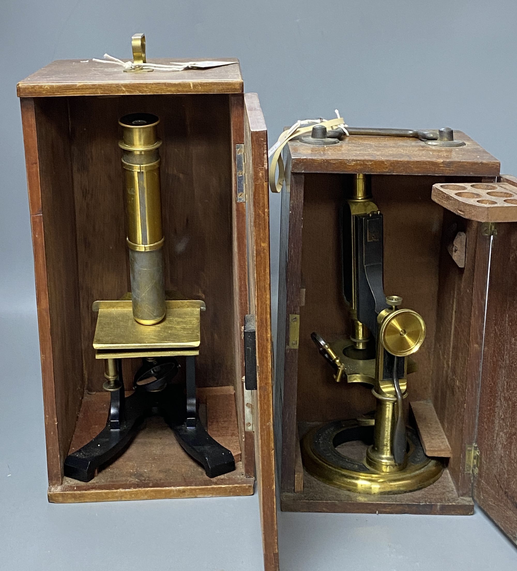 A lacquered brass monocular Universal Microscope by Smith & Beck, London, No. 2911 and another monocular microscope, H 30cm & 35cm